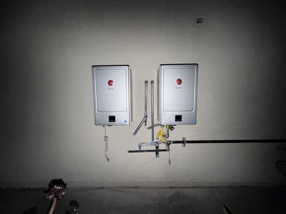 Two Rheem tankless units installed in a garage