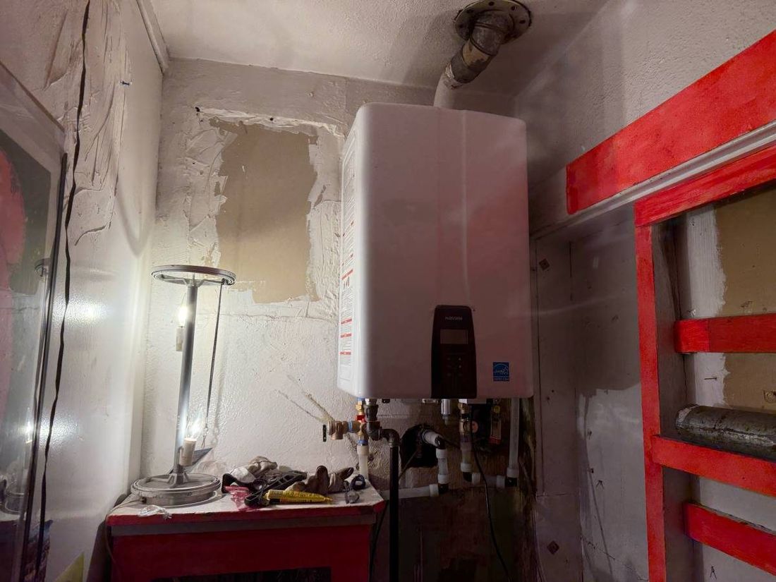 Tankless water heater installed in a closet