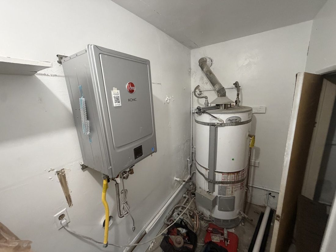 New Rheem IKONIC beside the old tank it replaced