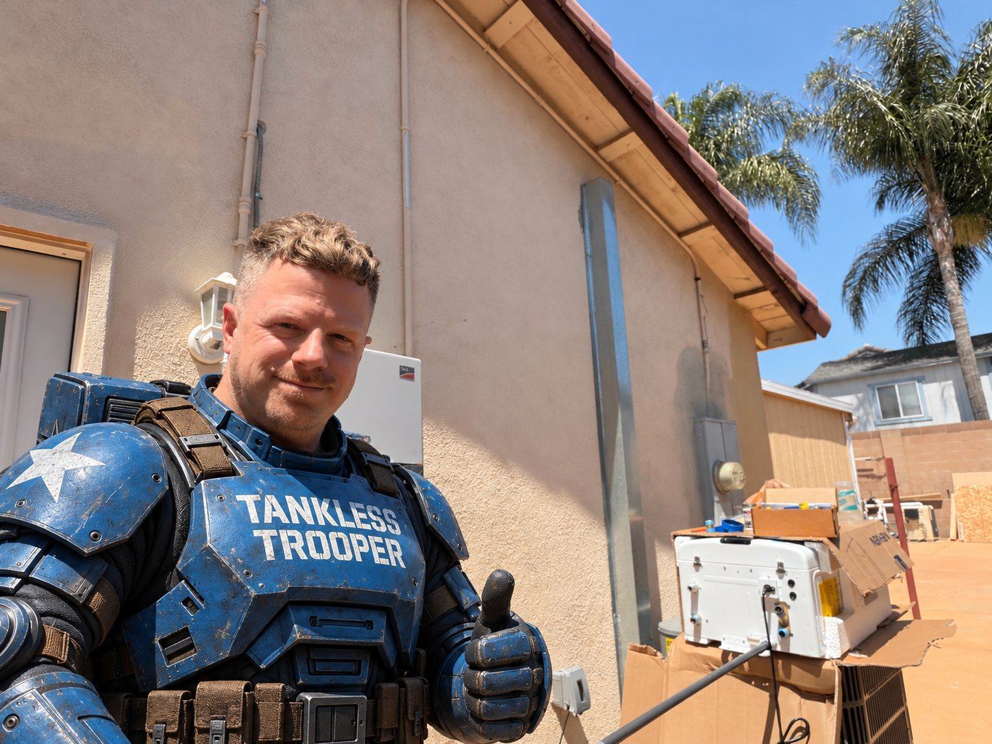 Jay in Tankless Trooper armor giving a thumbs up beside a new tankless unit